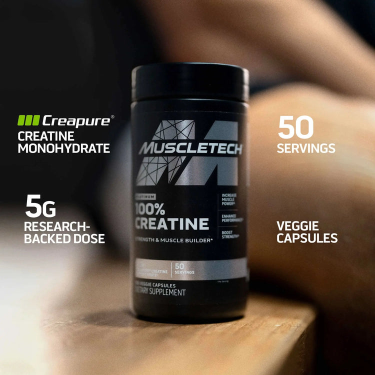 MuscleTech Platinum Creatine Creapure bottle on a wooden surface, showing 5g research-backed dose and 50 servings