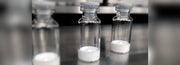 Glass vials of freeze-dried peptide powder on a laboratory bench