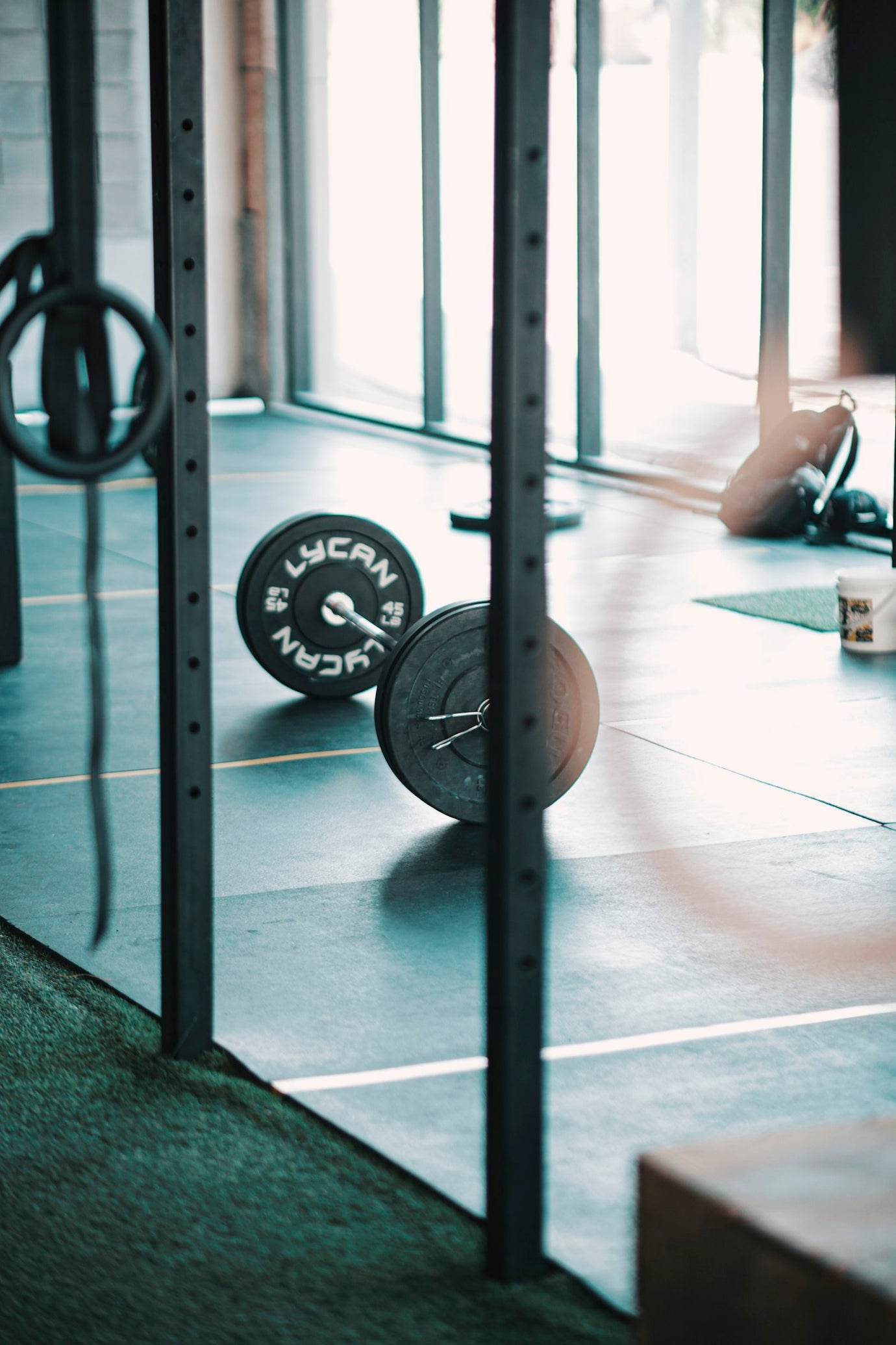 Barbell loaded with weight plates in a gym, illustrating a stim-free pre-workout training session